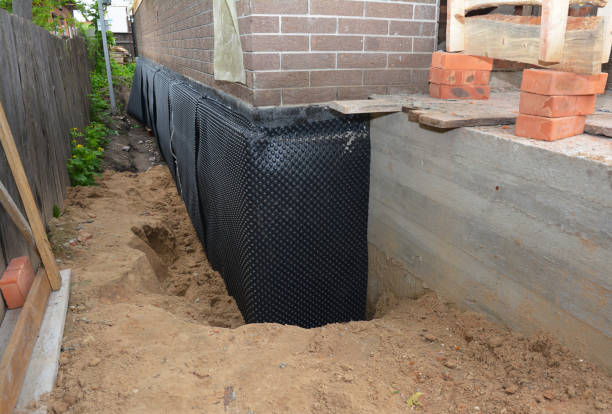Happy homeowners after waterproofing job in Boon